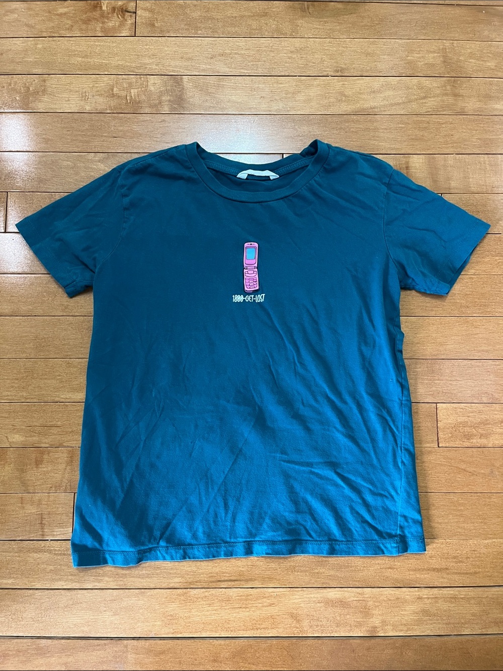 “1-800-GET-LOST” Teal Graphic Crewneck T‑Shirt with Pink Flip Phone Graphic